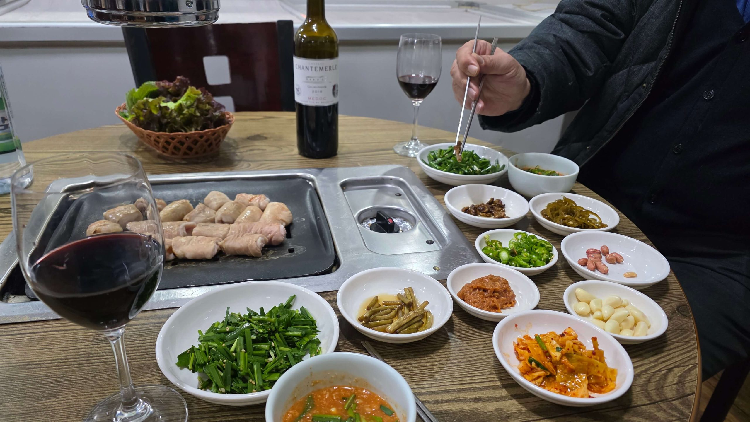grilled pork and side dishes with wine during an eating out meal
