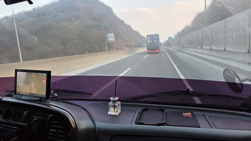 highway view from the passenger seat of a tow truck