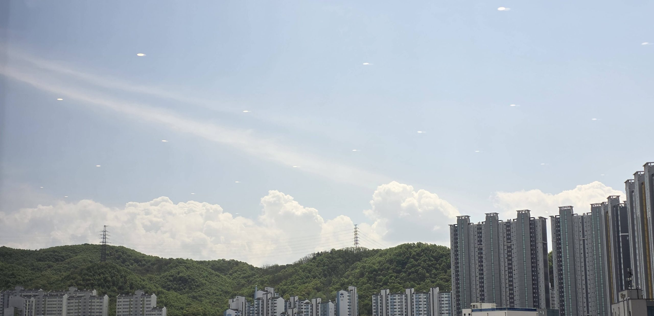 soft light across the sky with quiet clouds and distant hills