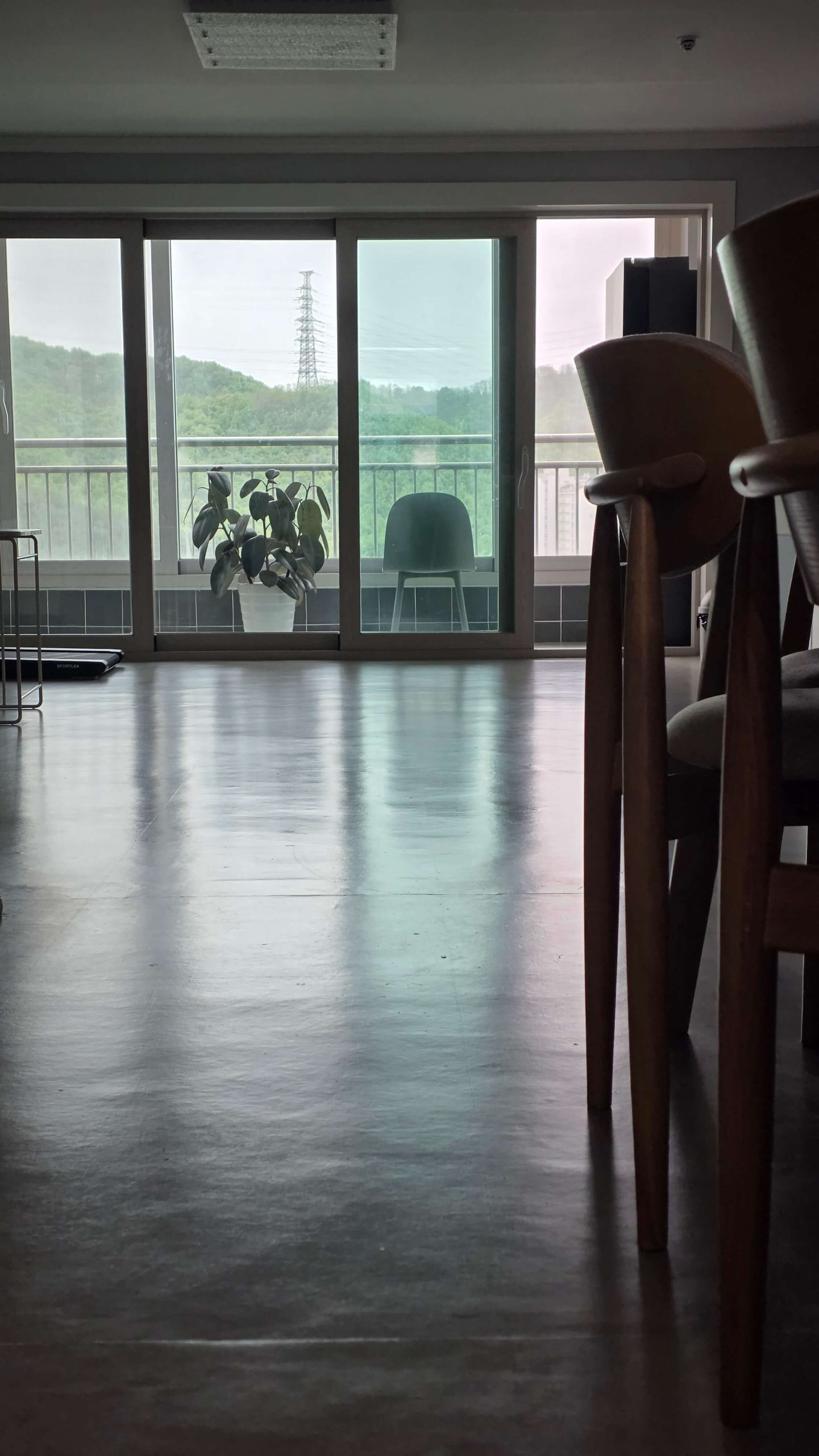 quiet living room floor with soft morning light and open window