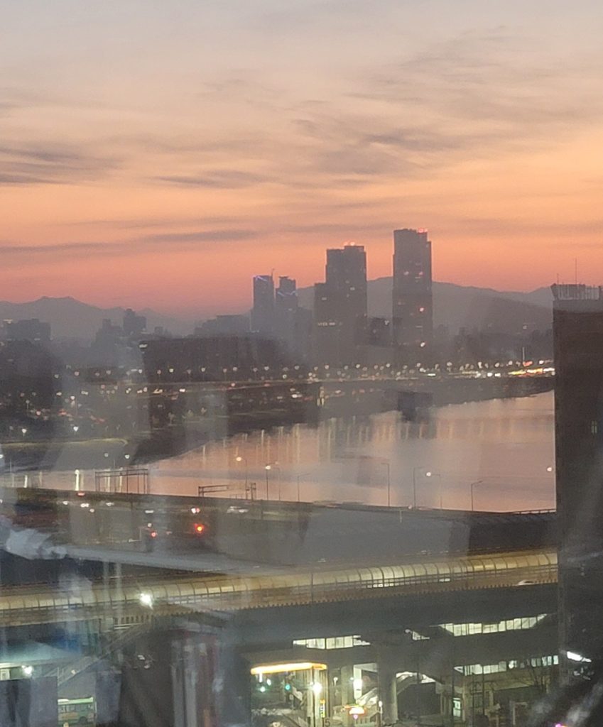 Quiet sunset view of the Han River seen from an apartment window in Seoul