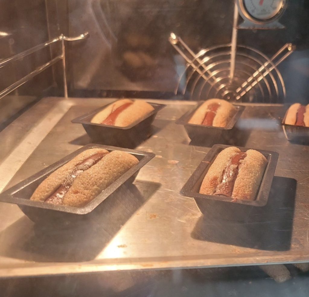 Small cakes baking inside an oven in a cozy officetel kitchen
