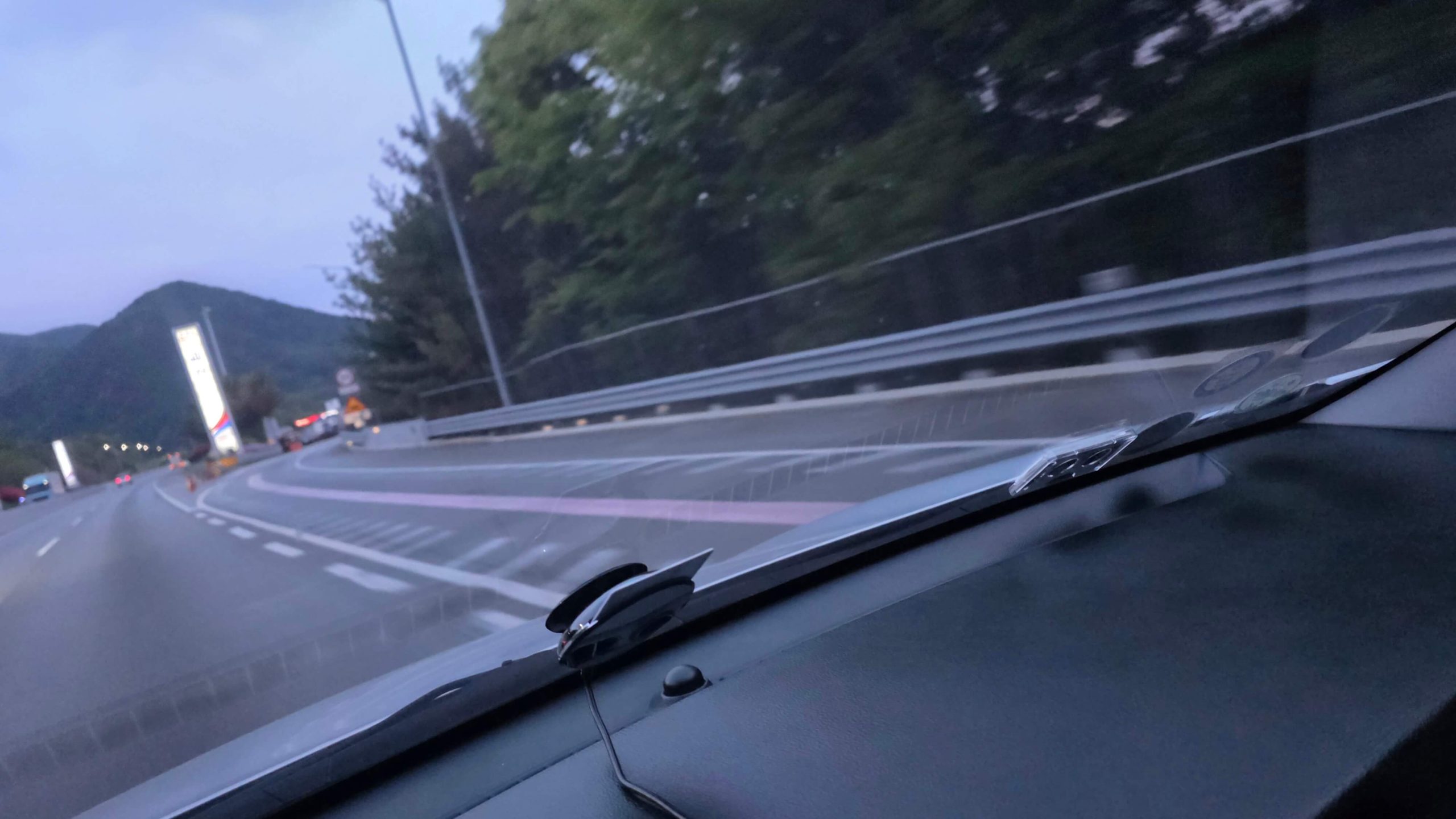 Driving past a highway rest area while lost in thinking mode during a long evening drive