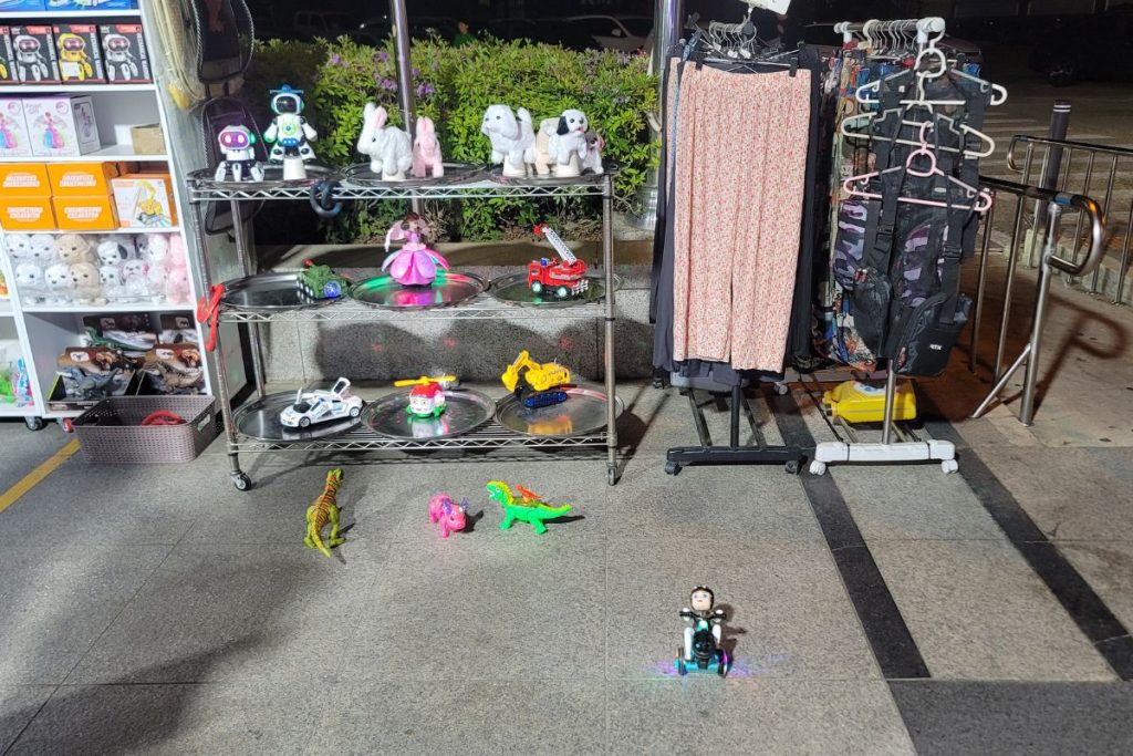 small moving toy robots and animals at a nighttime highway rest stop in Korea
