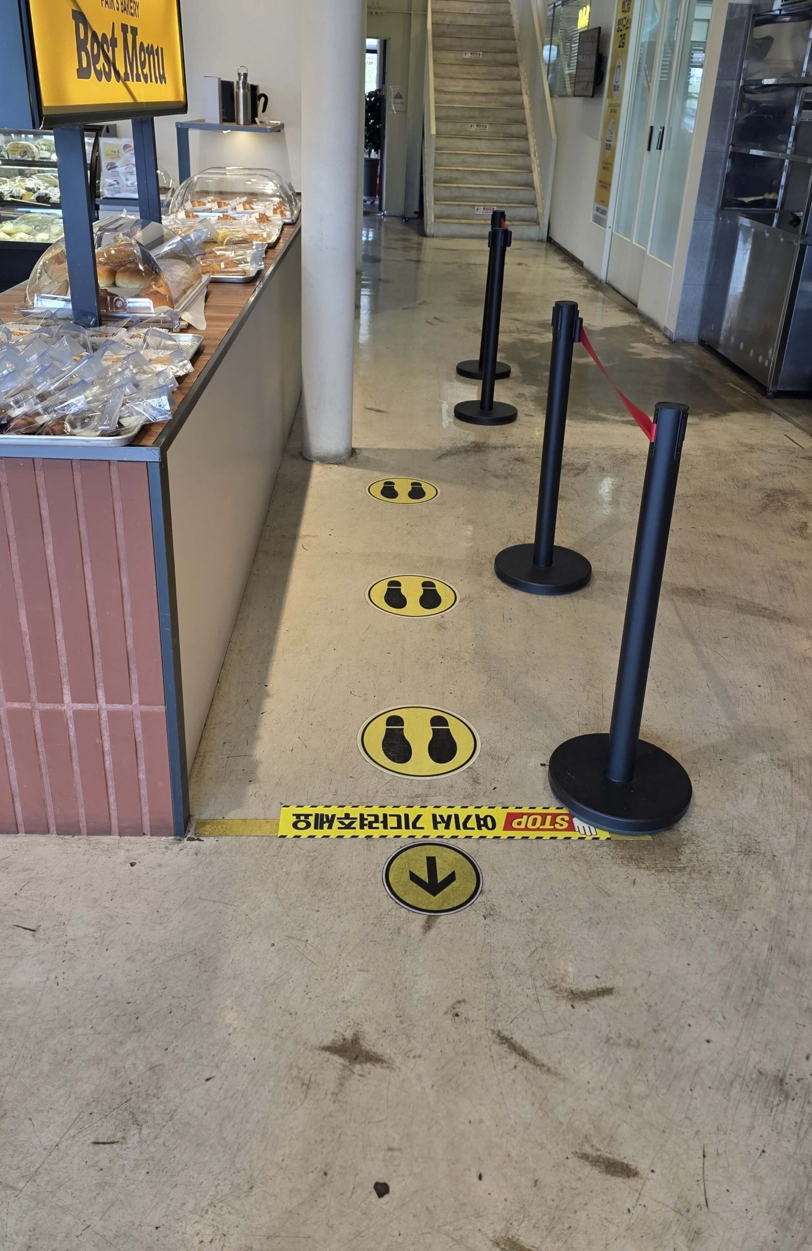 Footprint markers showing where customers are expected to wait in a café
