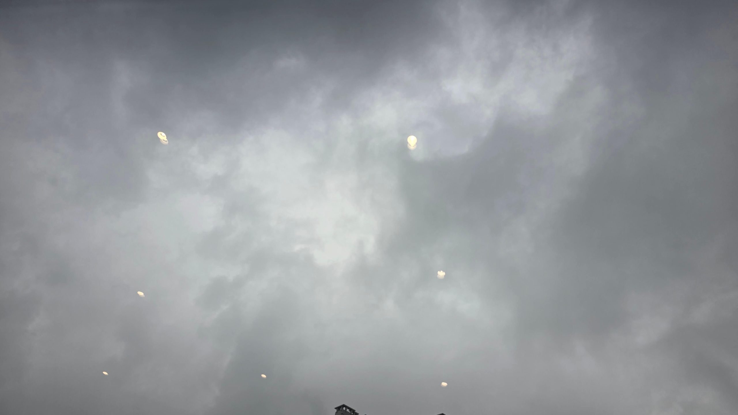 Storm clouds reflected on a café window before a quiet morning