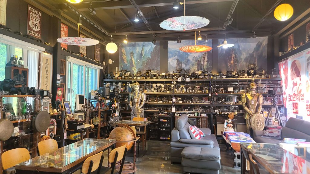 The upstairs collection of vintage cameras and antiques inside a quiet Coca-Cola café.