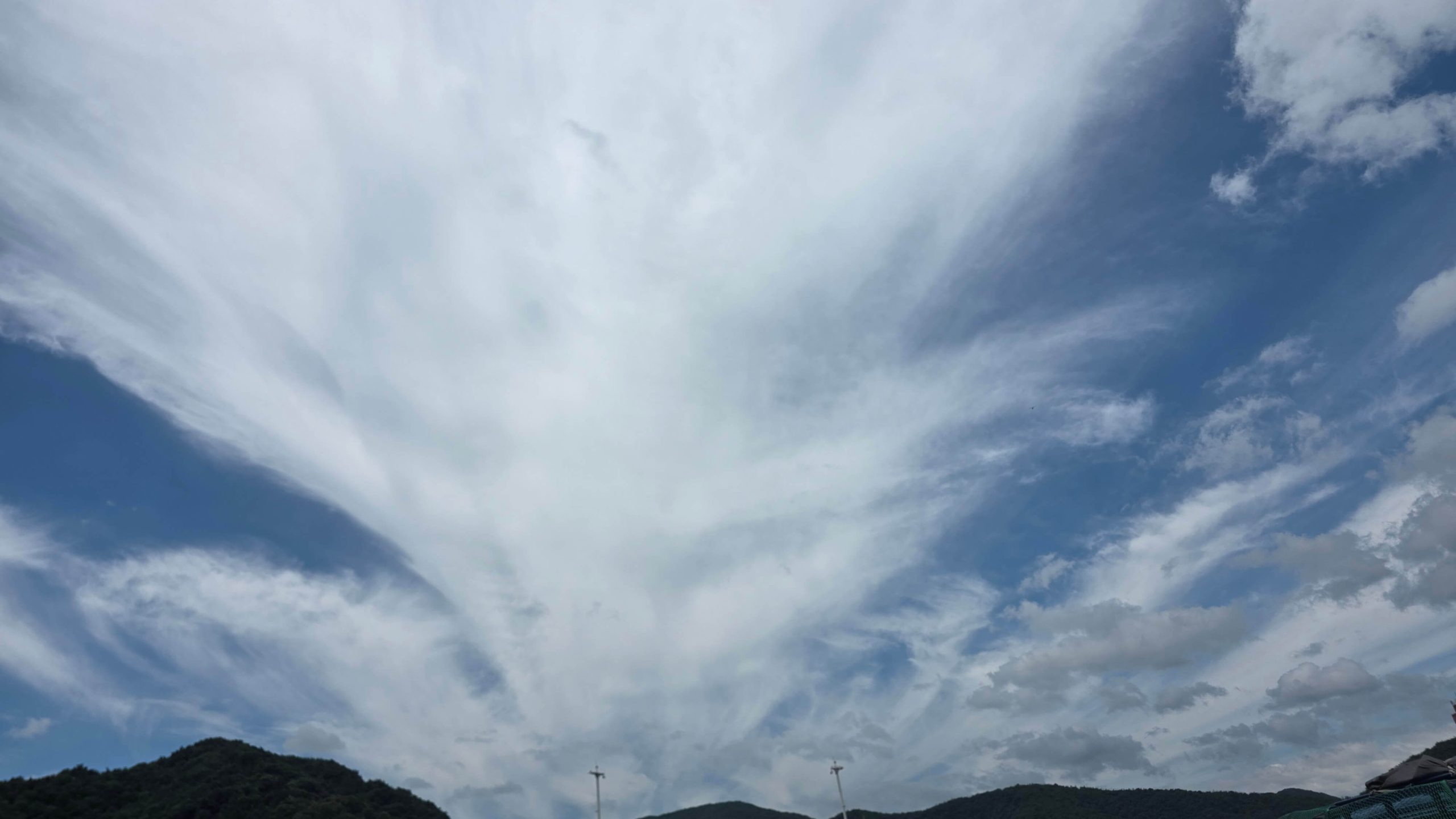 Wispy clouds moving across a blue summer sky