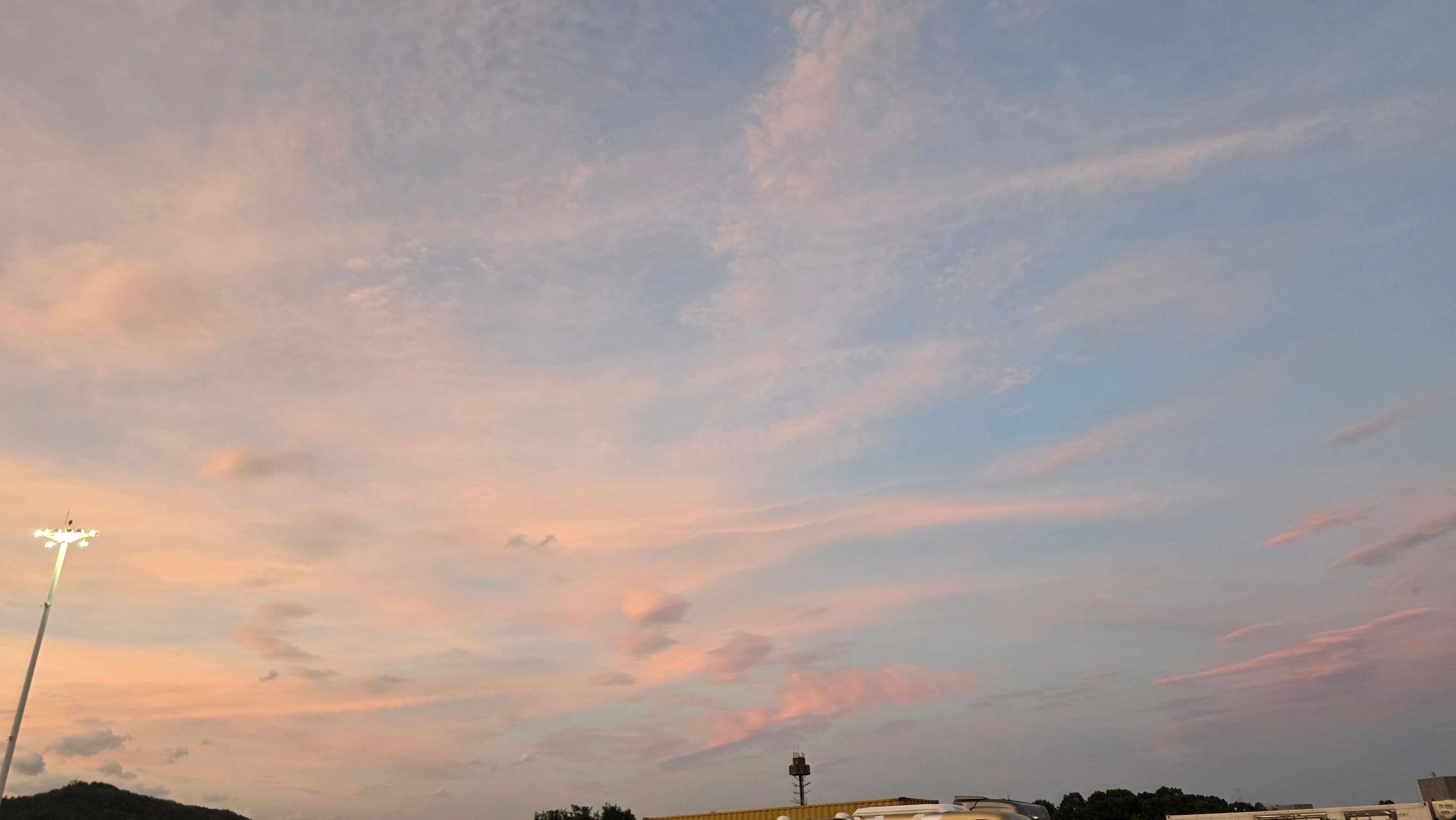 Soft evening sky after sunset, leaving room for reality to answer.