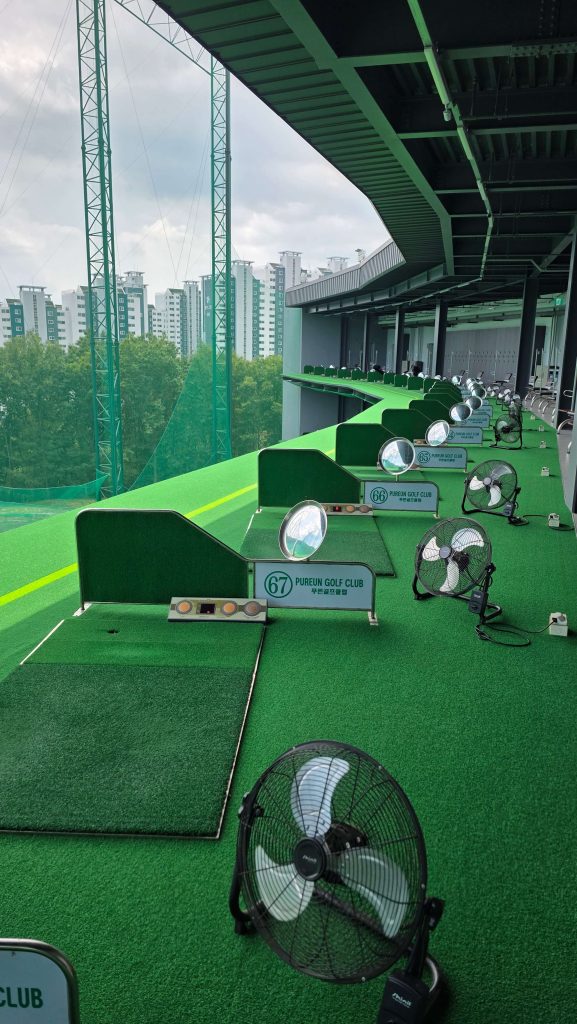 A quiet indoor driving range with empty practice bays