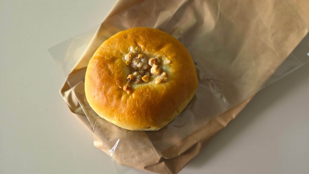 A red-bean bun in its opened paper wrapper