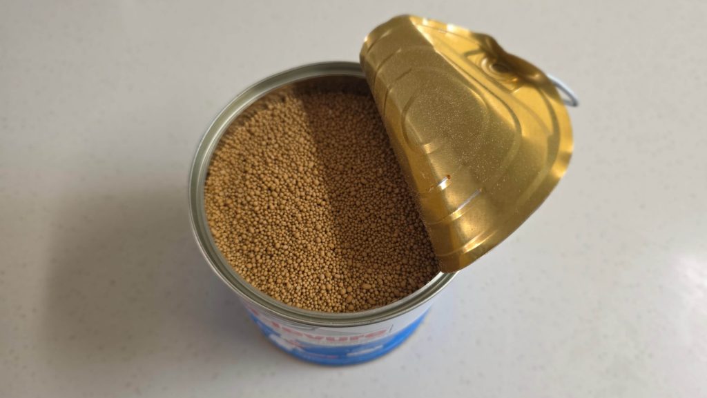 A partially opened can of dry yeast on the kitchen counter