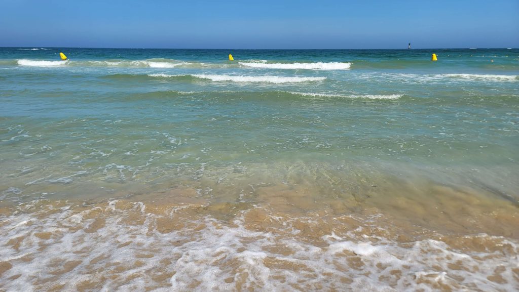 Waves rolling onto the shore after lunch by the sea