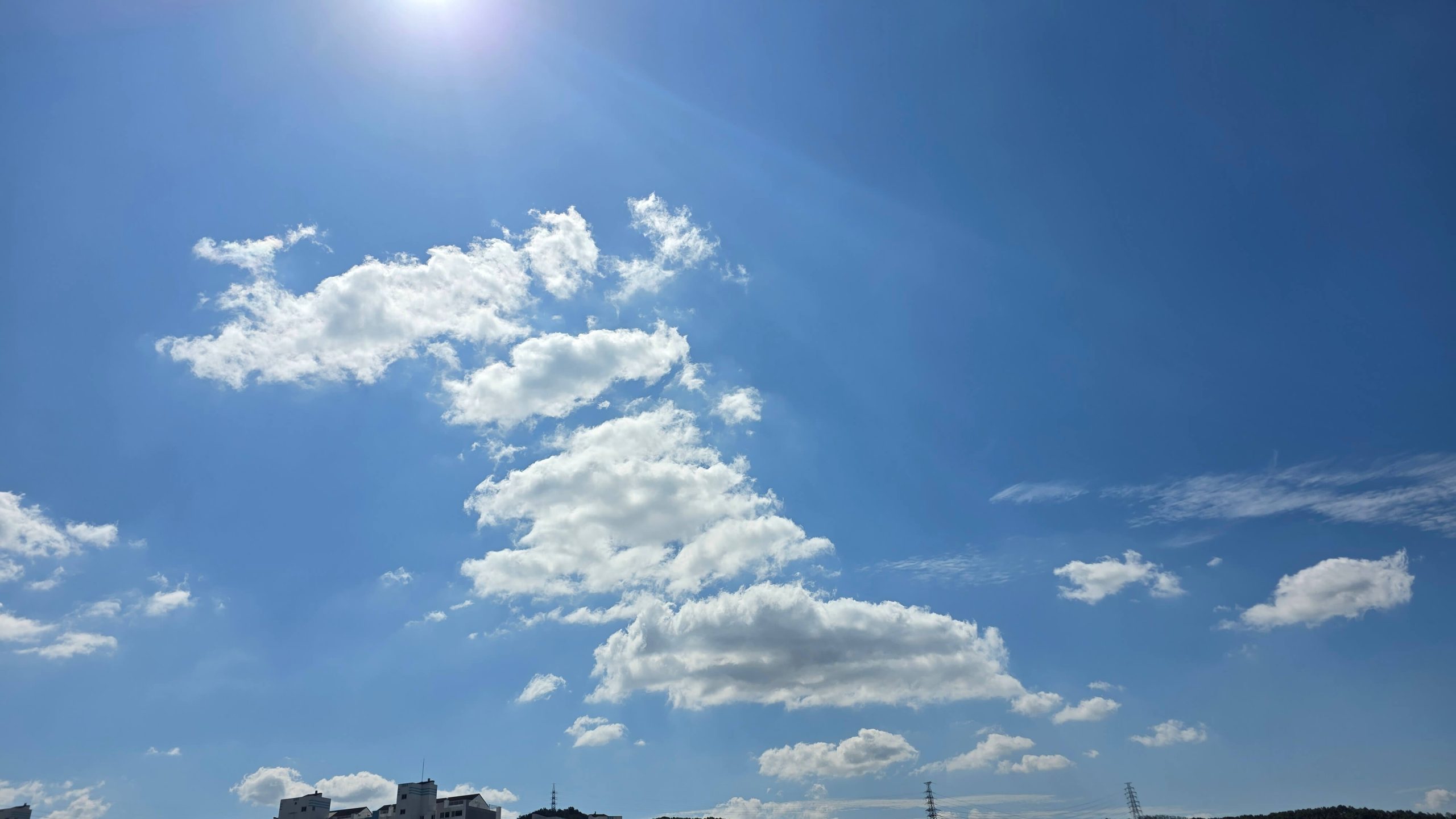 Wide blue sky with white clouds on a clear day