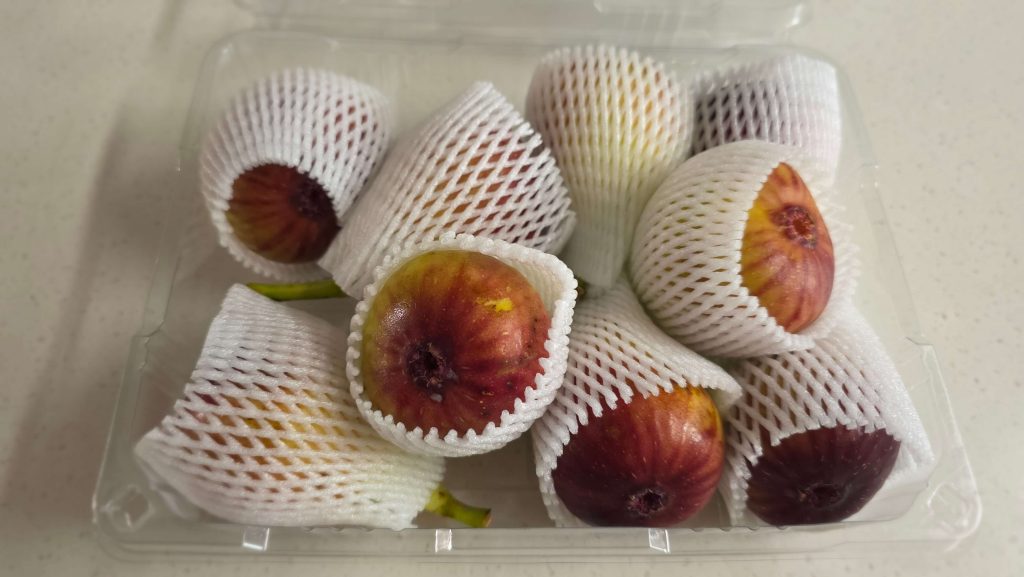Fresh figs in protective sleeves on the kitchen counter